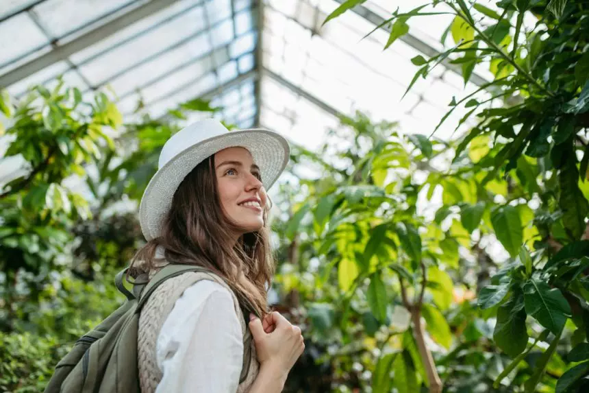 Portrait of young woman in botanical garden.