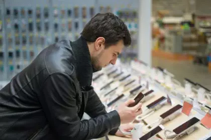 young male customer choosing smartphone