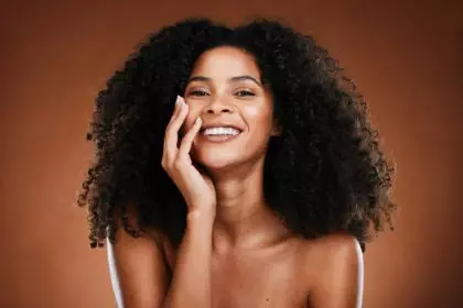 Black woman, hair and portrait with natural beauty smile for healthy cosmetic satisfaction. Beautif