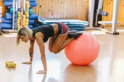 Woman Doing Pilates Exercises with a Ball