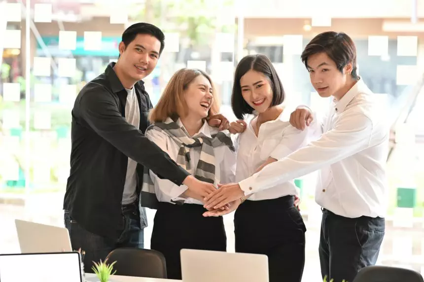 Business together, Four young business people confidently and motivation relax in modern office.