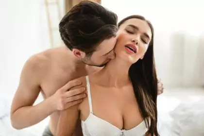 Passionate Man Kissing Womans Neck Having Sex In Bedroom Indoors
