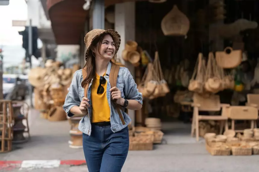Young beautiful woman traveling at the local market during vacation. Tourist women travel in Chiang
