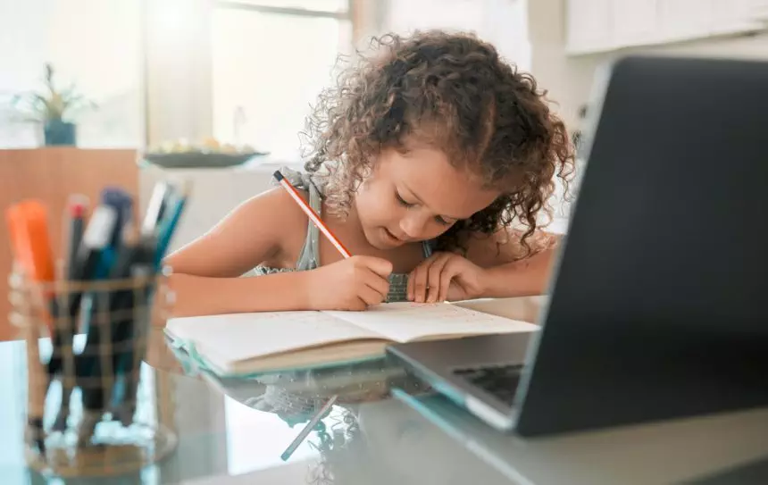 Zoom lesson, home school and online education with young girl, kid and student writing homework, te