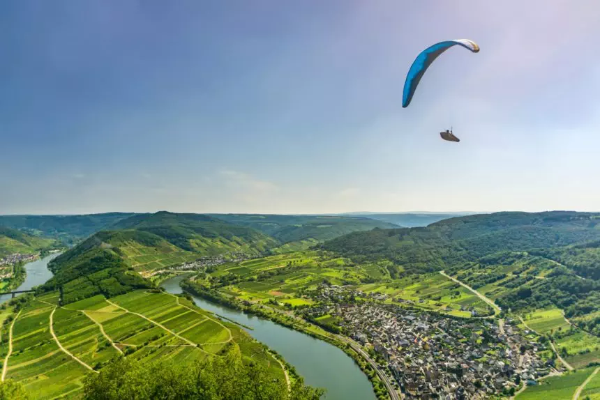 Paraglider flying over the Town Bremm on a summer day