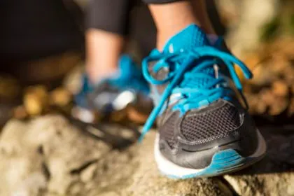 Running feet of young woman closeup on shoe