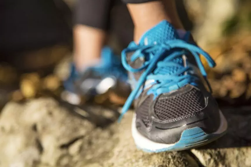 Running feet of young woman closeup on shoe