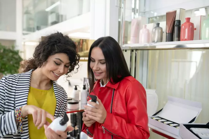 Two beaming ladies choosing hair care products