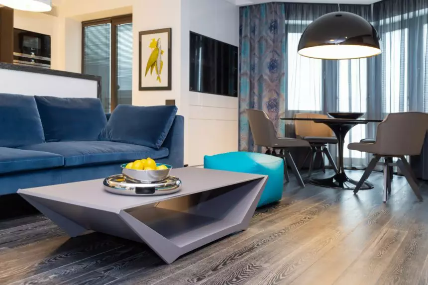 The design of a modern living room in blue, turquoise, gray tones with a yellow accent