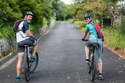 Athletic couple cycling on the open road
