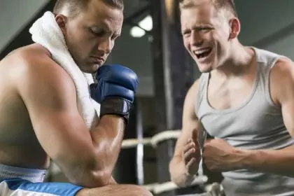 Trainer motivating boxer during training