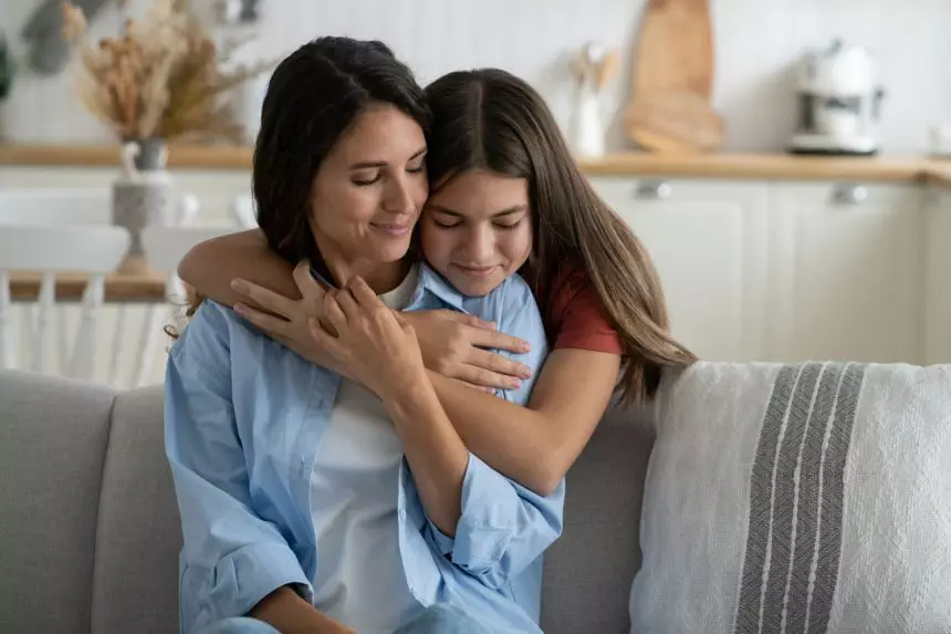 Teen daughter embracing mother expressing gratitude, telling mom she loves her. Mother-daughter bond