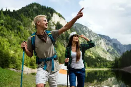 Adventure, travel, tourism, hike and people concept. Group of happy friends with backpack outdoors
