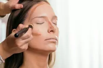 Make up artist contouring the face