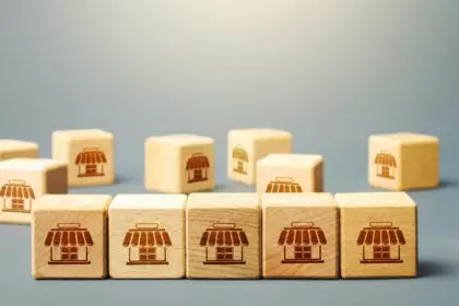 Blocks symbolizing shopping stores. Building a successful business empire. Franchise concept. Mergin