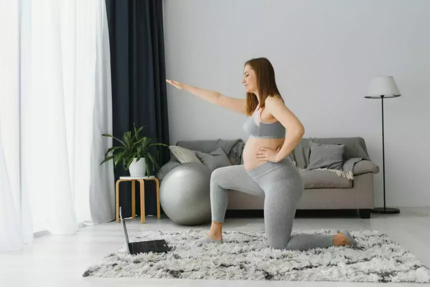 Female exercise, meditate during pregnancy. Online fitness class on digital devices.