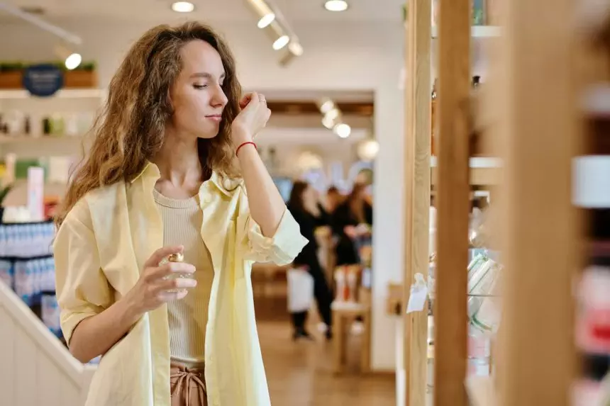 Woman choosing perfume in the store