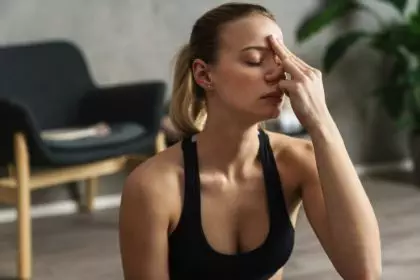 Attractive young woman practicing yogic breathing technique