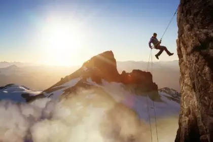 Epic Adventurous Extreme Sport Composite of Rock Climbing Man Rappelling from a Cliff