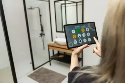Female hands holding digital tablet with smart home app
