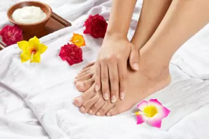 Hand on foot with healthy nails posing after a massage treatment