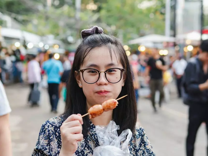 Woman Eating Street Food