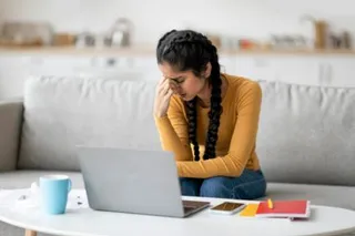 Stressed Young Indian Female Feeling Tired While Study With Laptop At Home